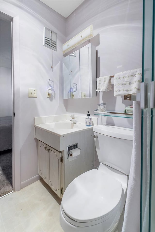 bathroom featuring visible vents, vanity, toilet, and baseboards