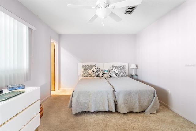 bedroom with visible vents, ceiling fan, light carpet, and baseboards