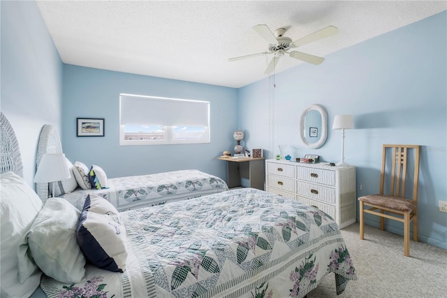 bedroom featuring light carpet, ceiling fan, and a textured ceiling