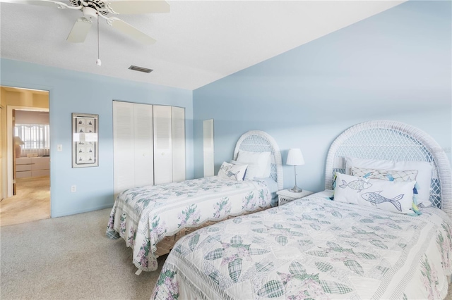 bedroom featuring a closet, visible vents, ceiling fan, and light carpet