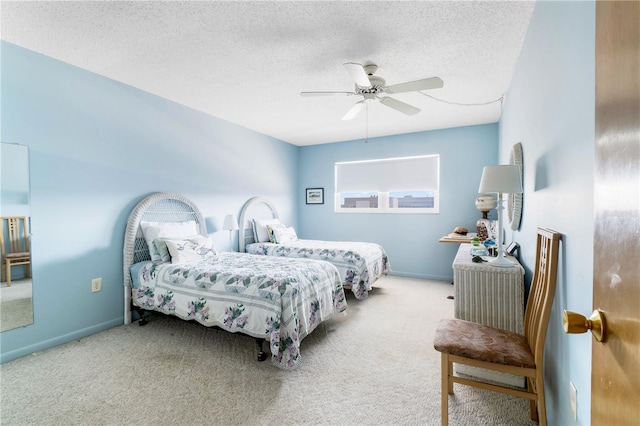 carpeted bedroom featuring a ceiling fan, a textured ceiling, and baseboards