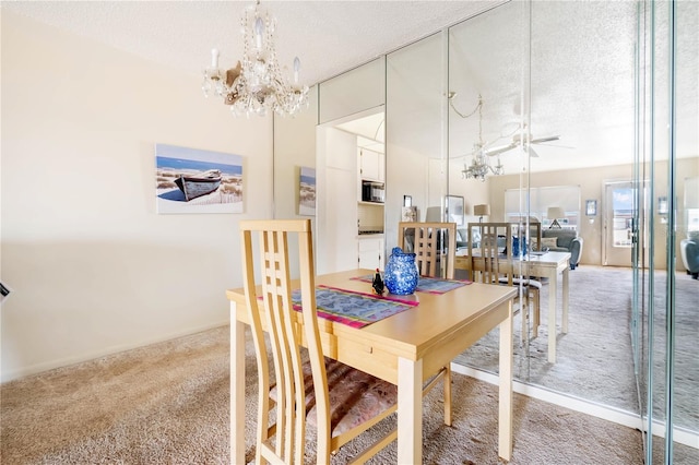 carpeted dining space featuring a chandelier and a textured ceiling