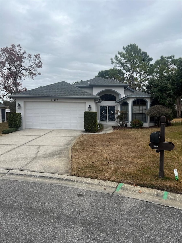 view of front facade with a garage and a front lawn