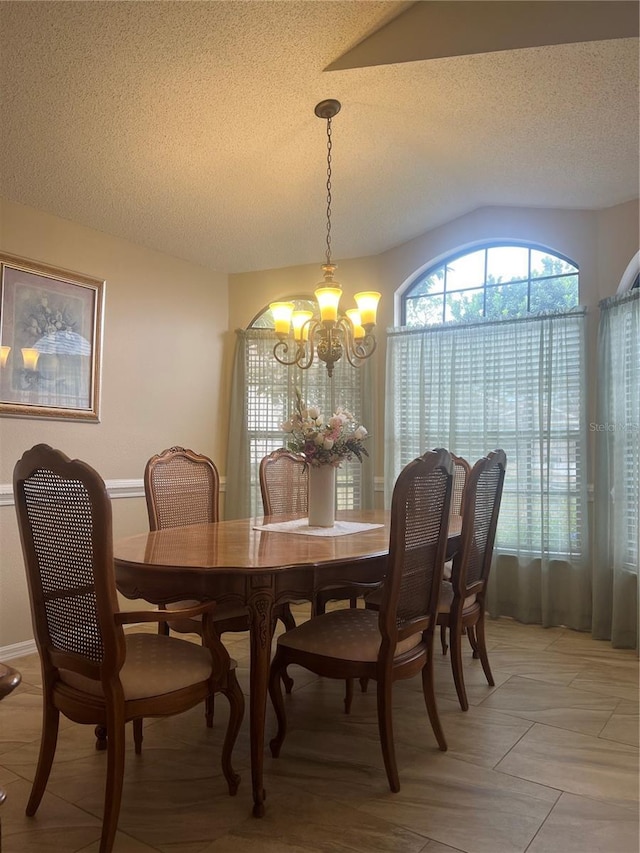 dining room featuring a notable chandelier and a textured ceiling