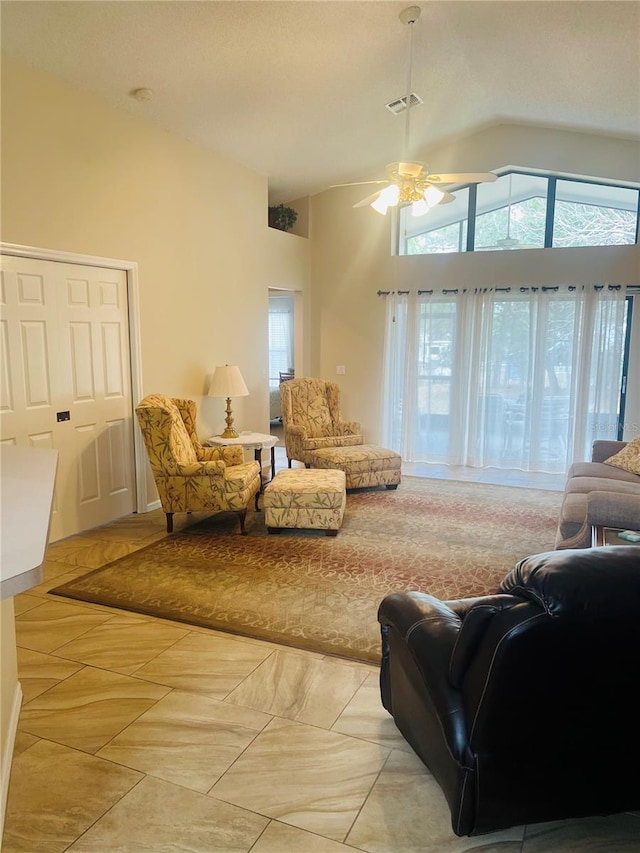 living room featuring high vaulted ceiling and ceiling fan