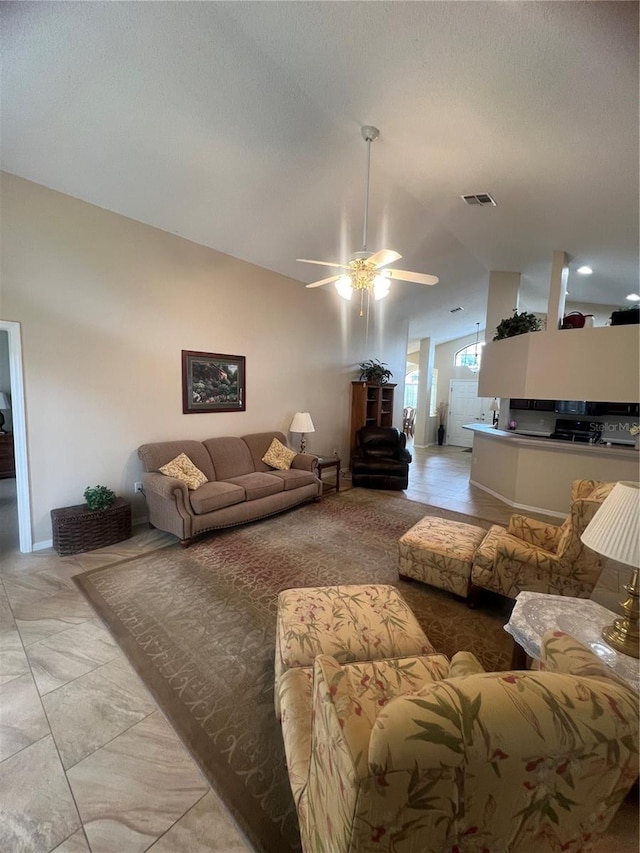 living room featuring lofted ceiling and ceiling fan