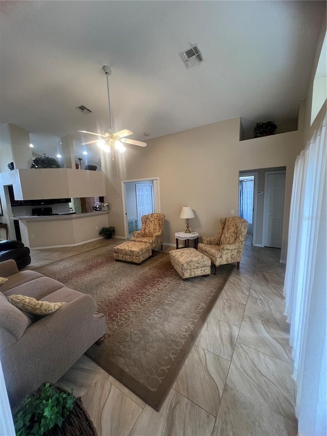 living room featuring ceiling fan and a textured ceiling