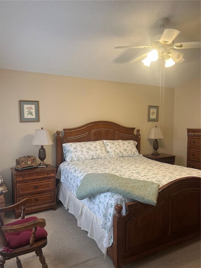 bedroom featuring ceiling fan, carpet flooring, and a textured ceiling