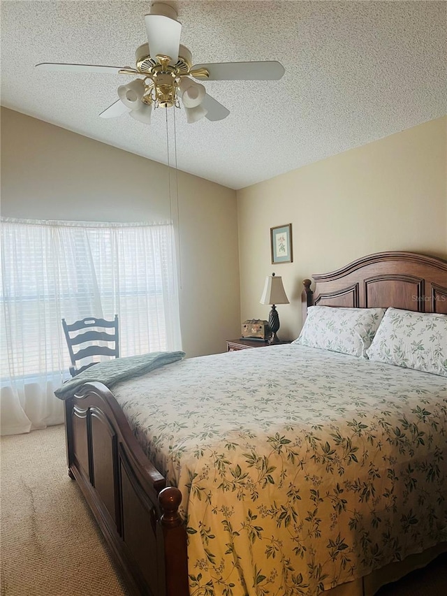 carpeted bedroom with ceiling fan, lofted ceiling, and a textured ceiling