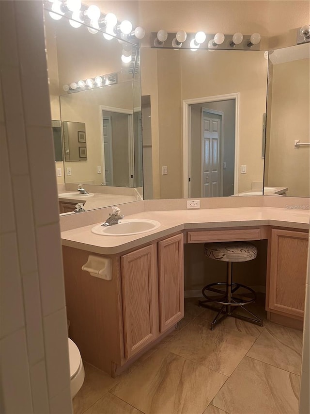 bathroom featuring vanity and toilet