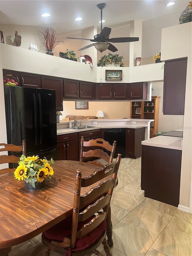 kitchen featuring dark brown cabinetry, sink, a towering ceiling, ceiling fan, and black appliances