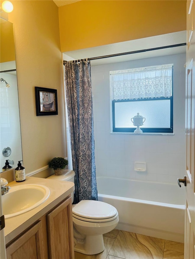 full bathroom with vanity, shower / tub combo, and toilet