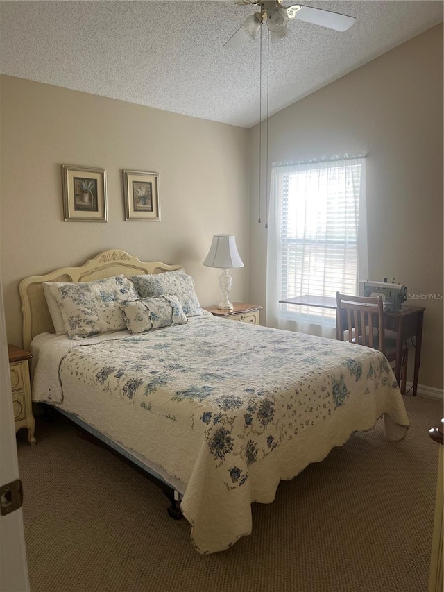 bedroom with ceiling fan, lofted ceiling, carpet, and a textured ceiling