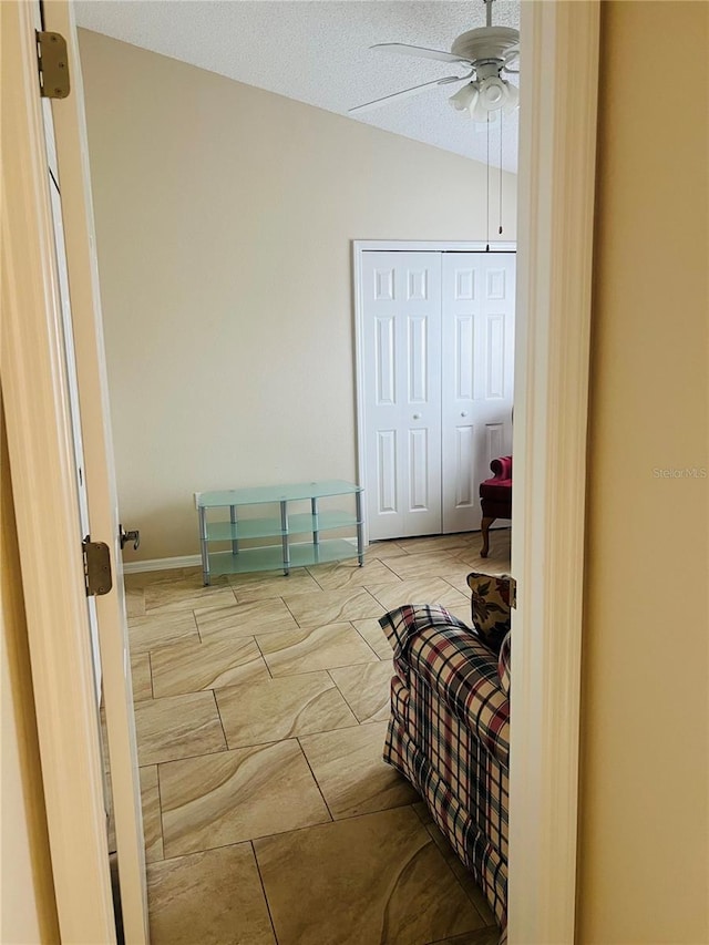 bedroom with ceiling fan, a closet, and a textured ceiling