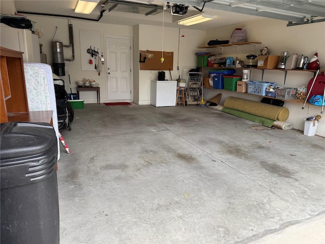 garage featuring a garage door opener and fridge