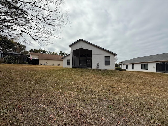 rear view of property with a yard