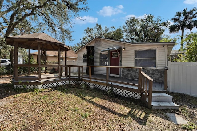 view of front of home featuring a wooden deck and a gazebo