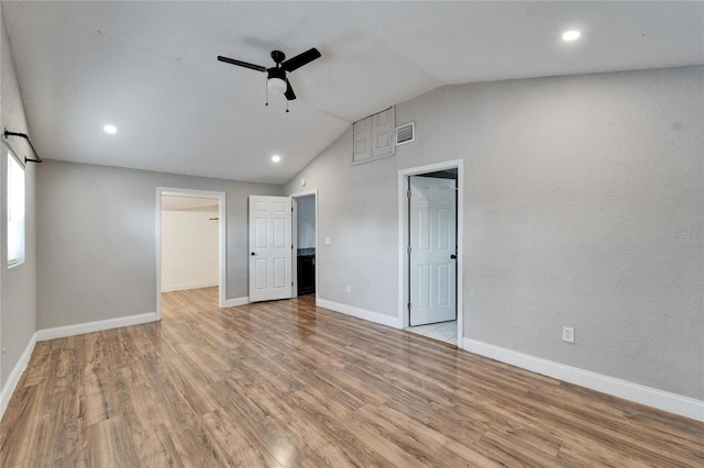 empty room with lofted ceiling, ceiling fan, and light wood-type flooring