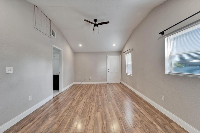 spare room featuring ceiling fan, vaulted ceiling, and wood-type flooring