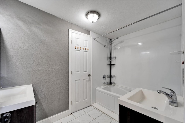 bathroom with vanity, a textured ceiling, and  shower combination