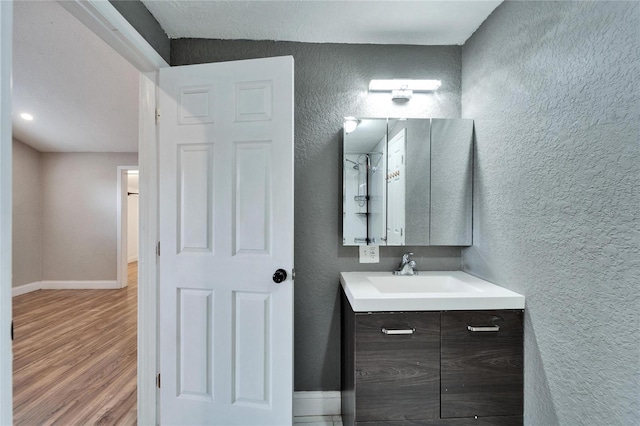 bathroom with vanity and wood-type flooring