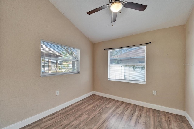 spare room featuring lofted ceiling, hardwood / wood-style floors, and ceiling fan