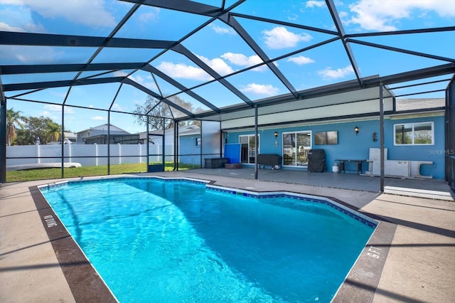 view of swimming pool with a lanai and a patio area