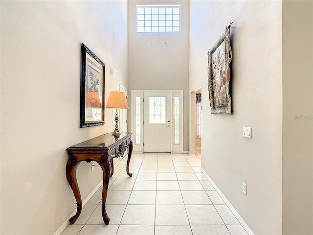 interior space featuring light tile patterned flooring and a high ceiling