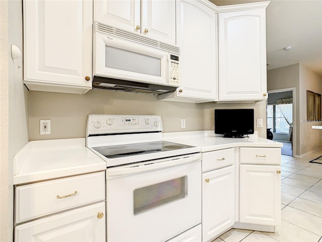 kitchen featuring white cabinetry, white appliances, and light tile patterned flooring