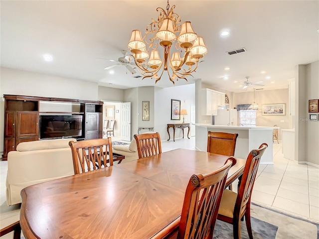 dining space with light tile patterned floors and ceiling fan with notable chandelier