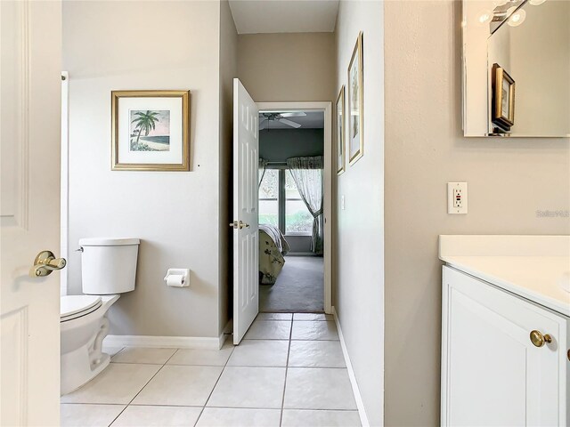 bathroom featuring ceiling fan, tile patterned floors, vanity, and toilet