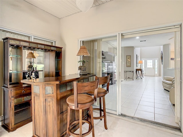 bar with french doors and light tile patterned flooring