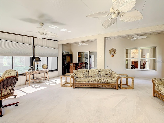 carpeted living room featuring ceiling fan