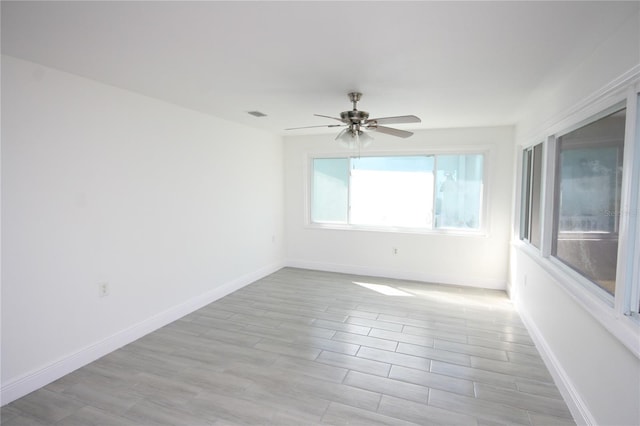 empty room featuring ceiling fan and light wood-type flooring