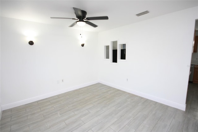 spare room featuring ceiling fan and light hardwood / wood-style flooring