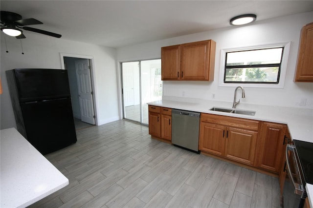 kitchen featuring sink, light wood-type flooring, black refrigerator, stainless steel dishwasher, and electric range