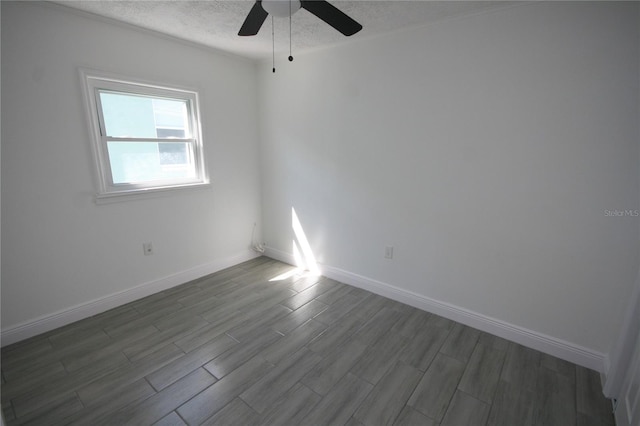 empty room featuring ceiling fan, hardwood / wood-style floors, and a textured ceiling