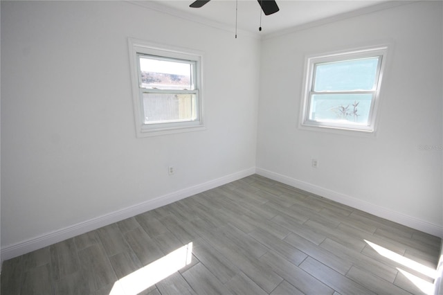 spare room featuring ornamental molding, ceiling fan, and light wood-type flooring