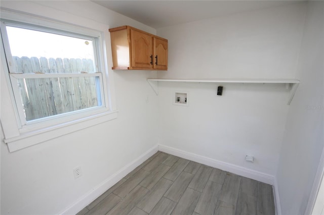 laundry room with cabinets, washer hookup, and light hardwood / wood-style flooring