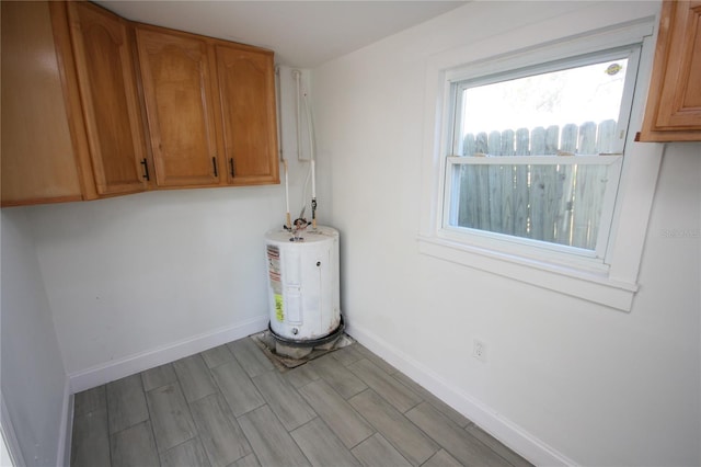 clothes washing area with water heater