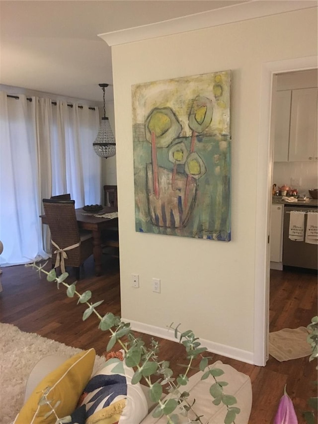 interior space featuring baseboards and wood finished floors