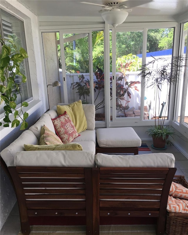 sunroom / solarium featuring ceiling fan