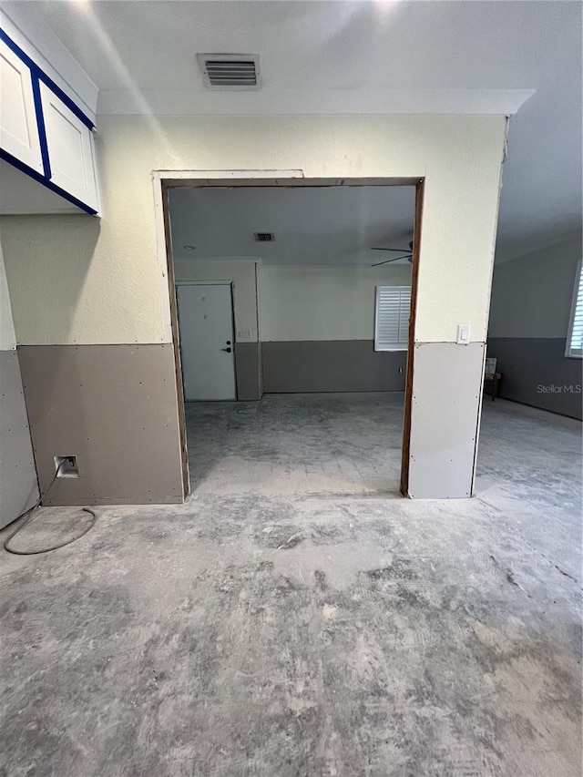 interior space with unfinished concrete flooring and visible vents