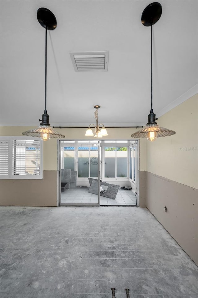 empty room featuring visible vents, unfinished concrete flooring, and ornamental molding