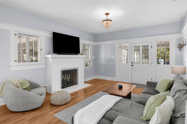 living room with wood-type flooring and a fireplace