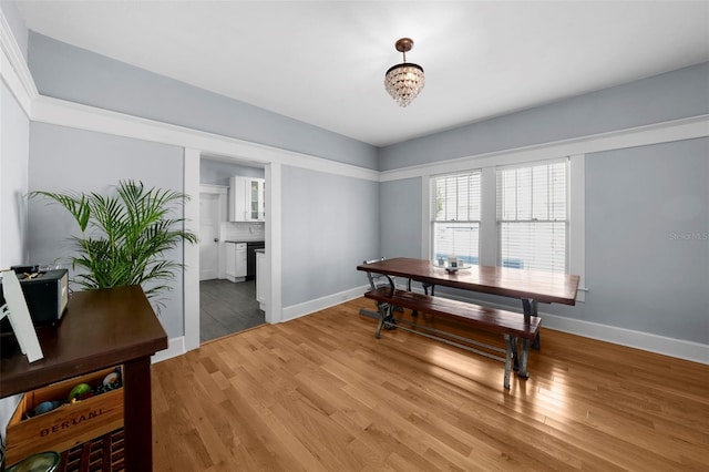 dining room with a fireplace and light hardwood / wood-style floors