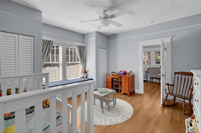 interior space featuring ceiling fan, light hardwood / wood-style floors, and a textured ceiling