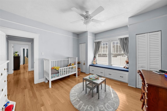 bedroom with ceiling fan, light hardwood / wood-style floors, and a textured ceiling