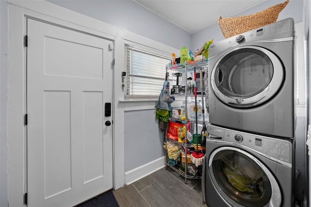 laundry room featuring stacked washer and dryer and dark hardwood / wood-style floors