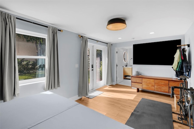 bedroom featuring french doors, access to exterior, and light wood-type flooring